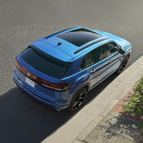 Overhead rear 3/4 shot of the 2025 Volkswagen Atlas Cross Sport parked on side of street