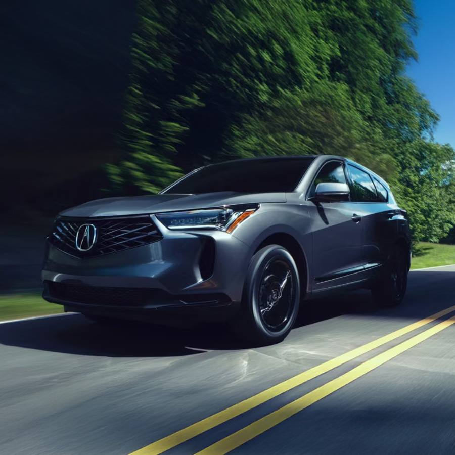 2026 Acura RDX in motion driving down a road