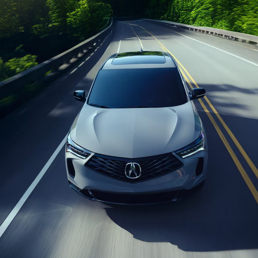 Front view of the 2026 Acura RDX driving down a road