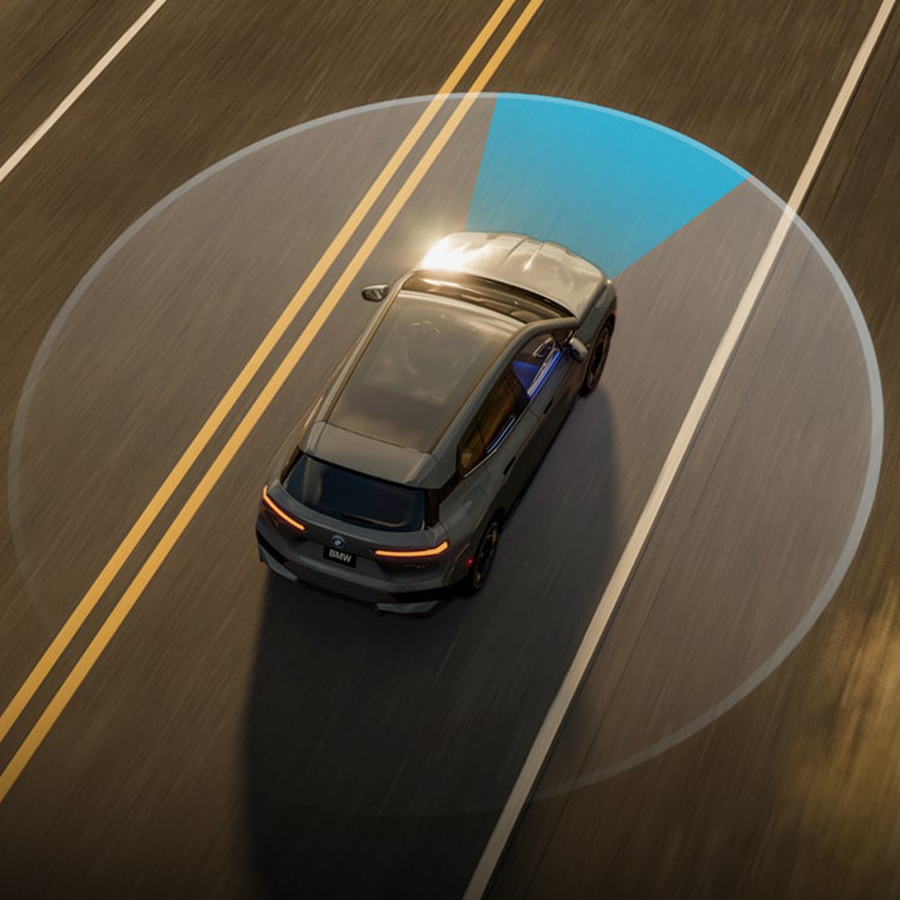 Aerial view of a BMW driving down an open road, showcasing sensor technology