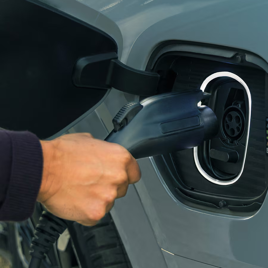 Close-up of Someone Inserting the EV Charger into the Port of a 2026 ESCALADE IQL