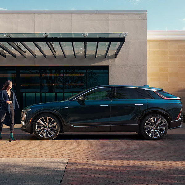 woman walking areound outside of new cadillac