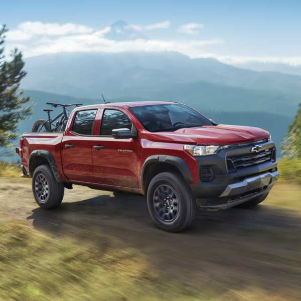 Three Quarters View of a Red 2026 Chevy Colorado Going through a Road at Mountain Top