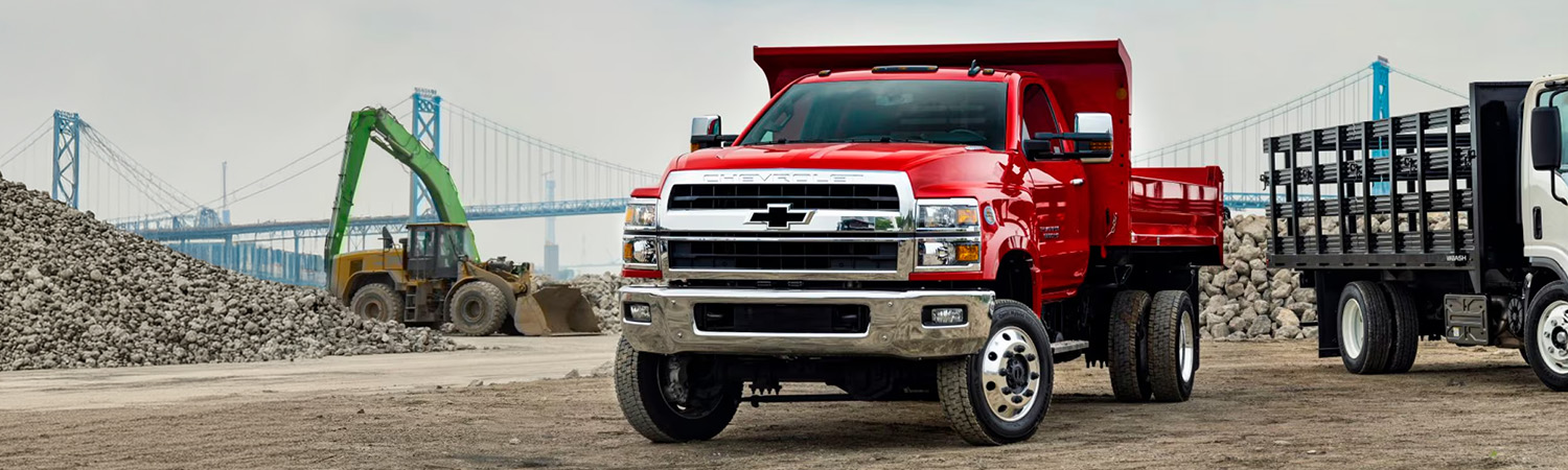 2025 Chevy Silverado Medium Duty Chassis Cab Parked on a Jobsite Near Construction Equipment