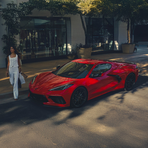 A Woman Walking Toward Her Parked 2026 Chevy Corvette Stingray