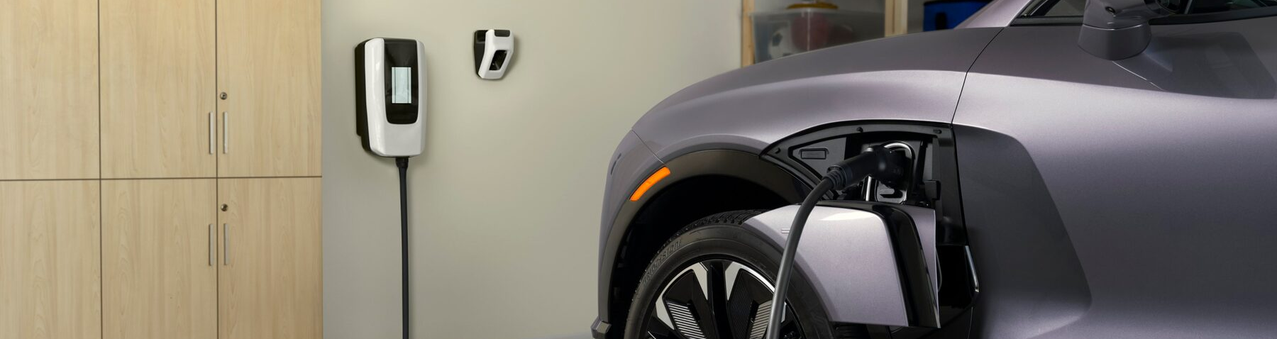 A Silver 2025 Chevrolet EV Is Getting Charged by an Indoor Charging Port
