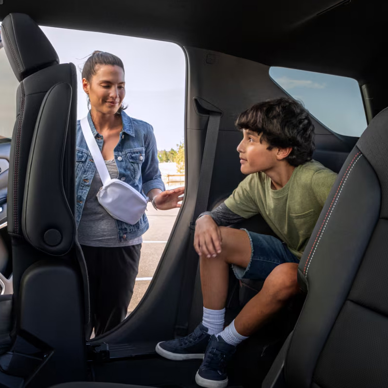 Mother assisting child out of car