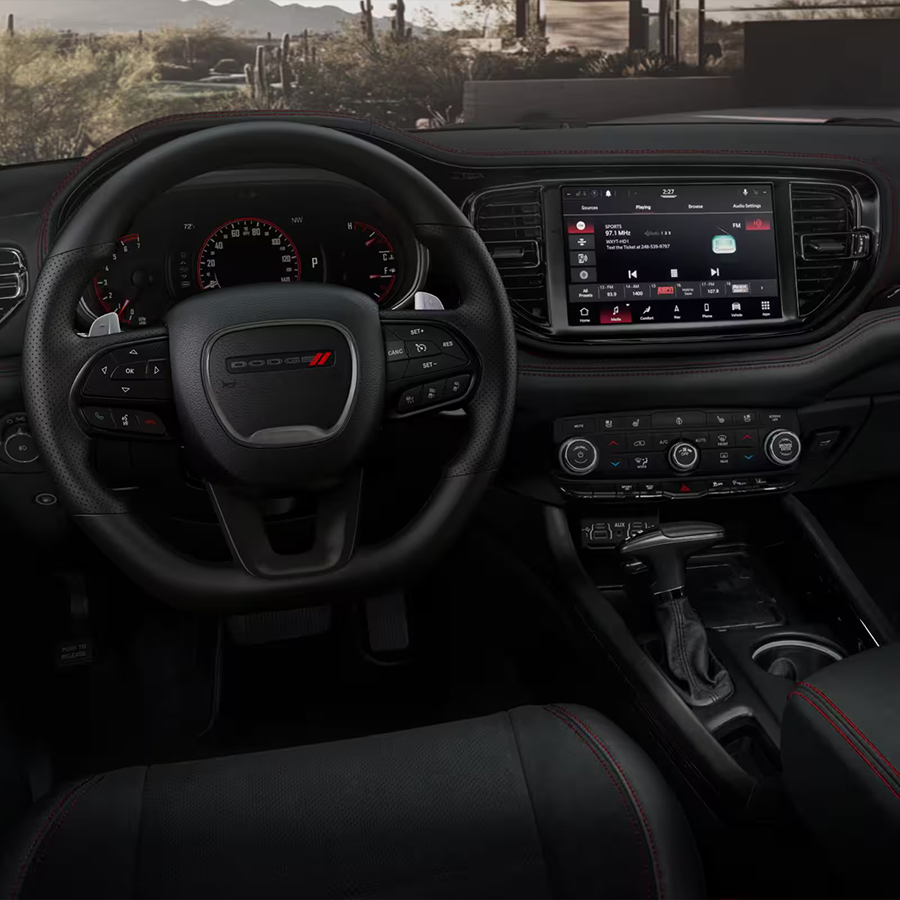 Interior of the 2026 Dodge Durango showing the steering wheel, digital gauges, and infotainment touchscreen.