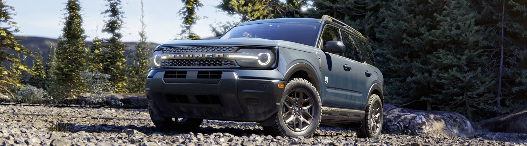 2026 Ford Bronco Sport® parked in the woods with trees surrounding the vehicle