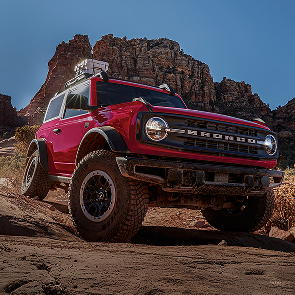 A 2026 Ford Bronco® SUV with the available Sasquatch® Package descending a muddy hill