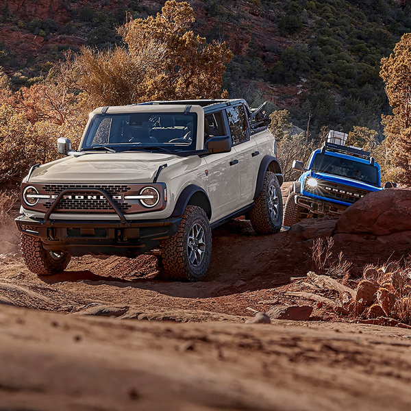 A line of 2026 Ford Bronco® SUVs parked next to each other on a mud flat