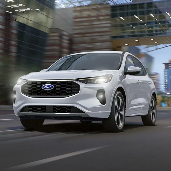 Front 3/4 shot of the 2026 Ford Escape driving down road