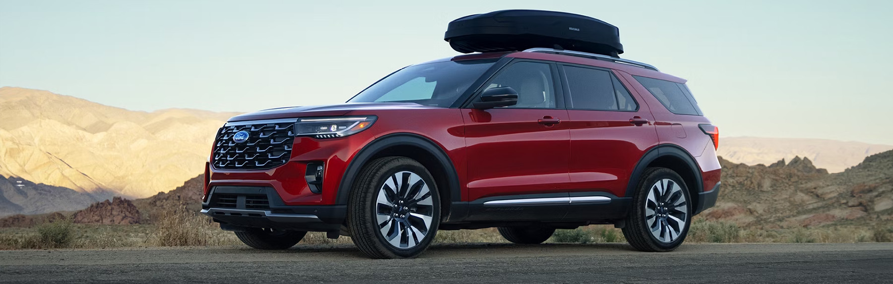 Ford Explorer parked with mountains and desert terrain in the background