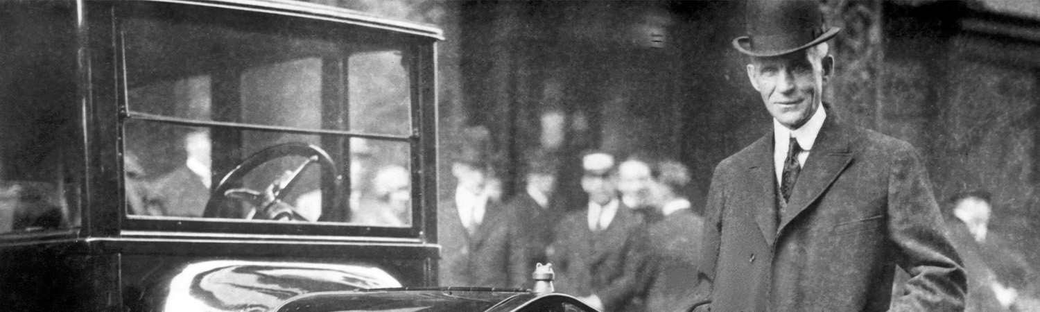 Picture of Henry Ford next to early Ford model