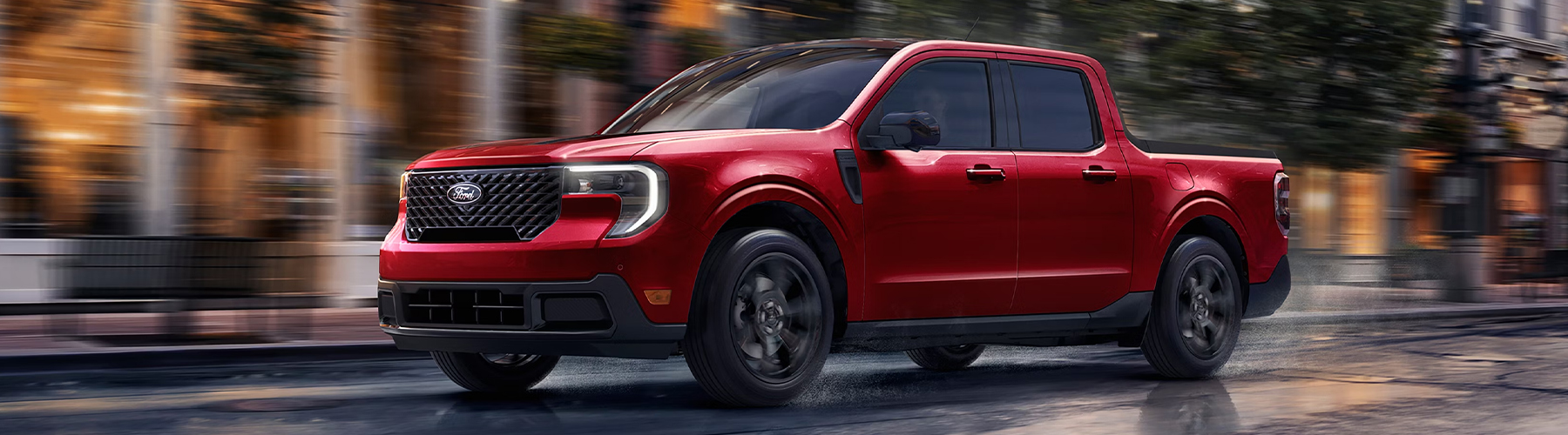 A Ford Maverick Lariat with Black Appearance Package driving on a city road.