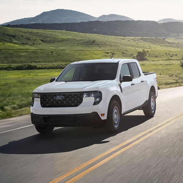 2026 Ford Maverick® pickup in Oxford White being driven on a country highway