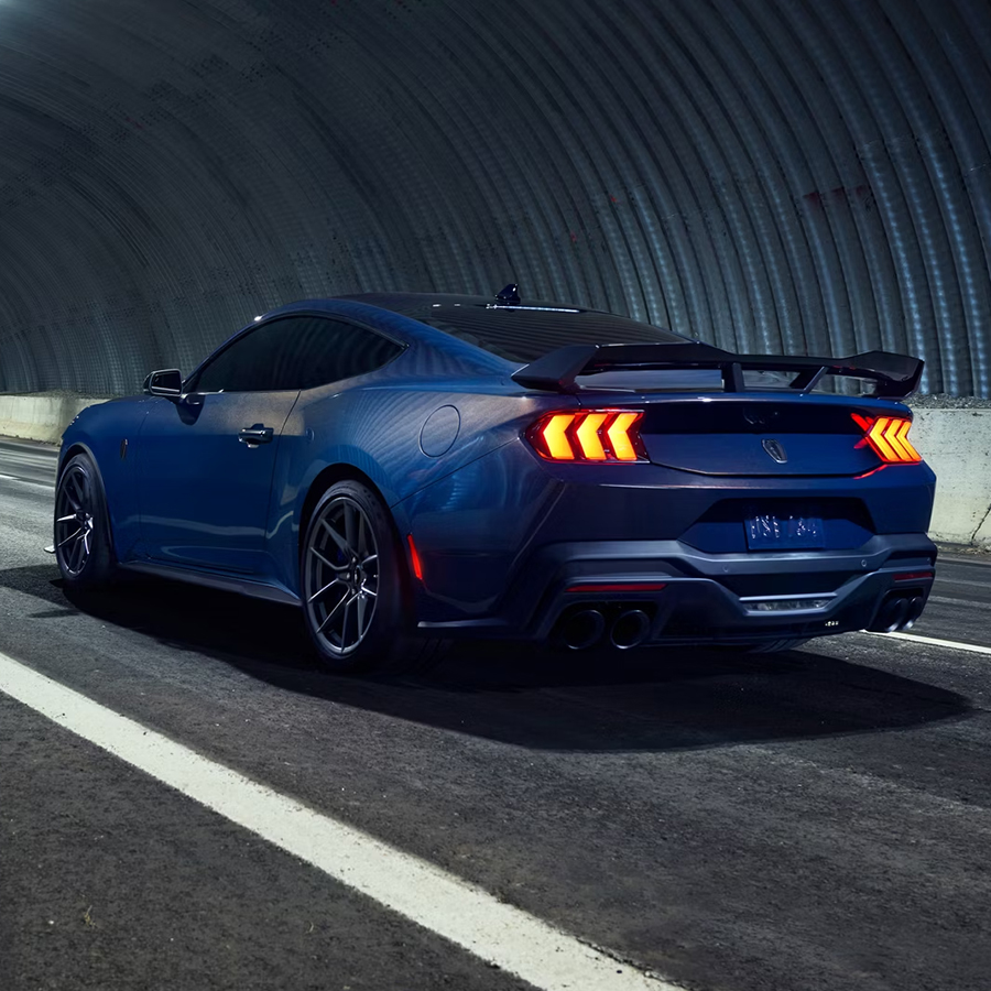 Ford Mustang® Dark Horse™ coupe in available Blue Ember Metallic being driven in a tunnel