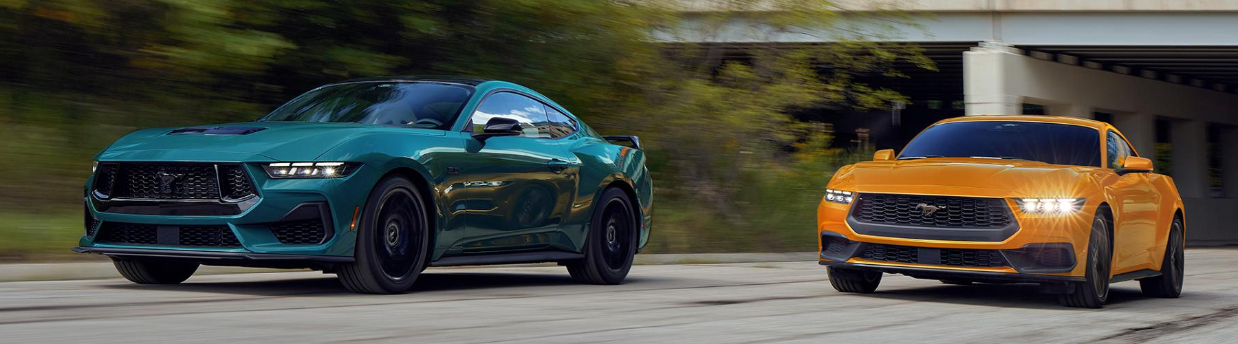 A 2026 Ford Mustang® GT Fastback and a 2026 Ford Mustang® EcoBoost® Fastback being driven on a highway