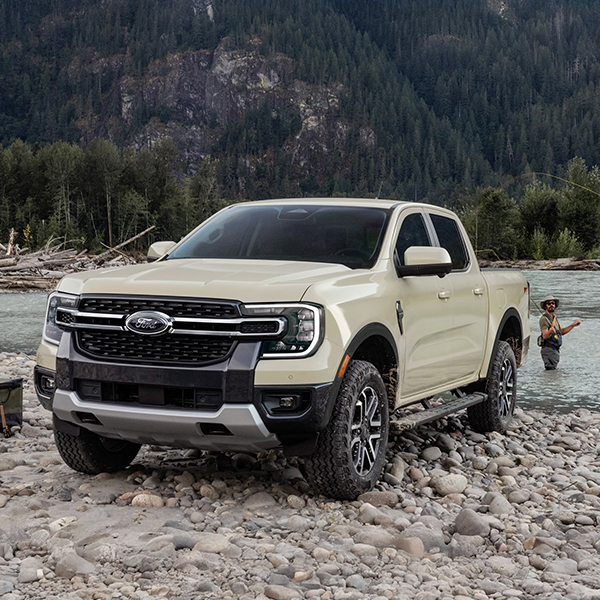 Two people fishing in a lake next to their 2026 Ford Ranger® truck