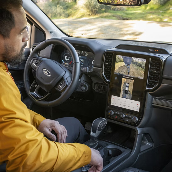 A person sitting in the driver's seat of their 2026 Ford Ranger® Lariat® model and using the 360-Degree Camera feature