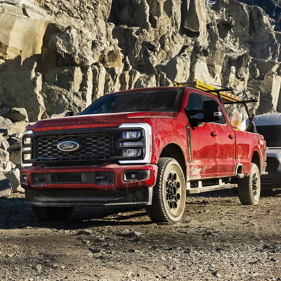 2025 Ford Super Duty® Lariat® sitting on a dirt road in front of a rock wall