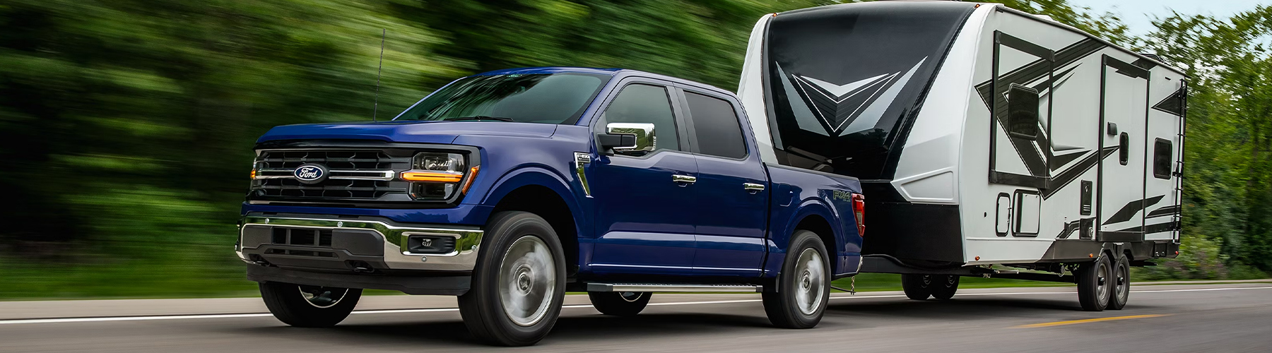 2026 Ford F-150® XL pickup in Atlas Blue Metallic pulling a camper