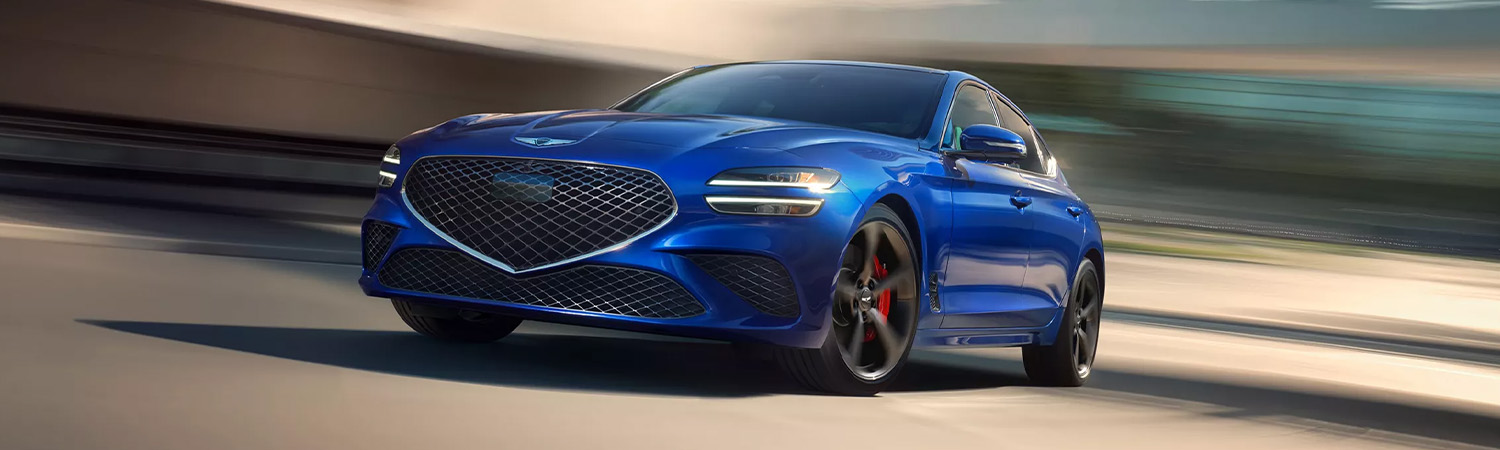 Front 3/4 shot of the 2026 Genesis G70 driving down road