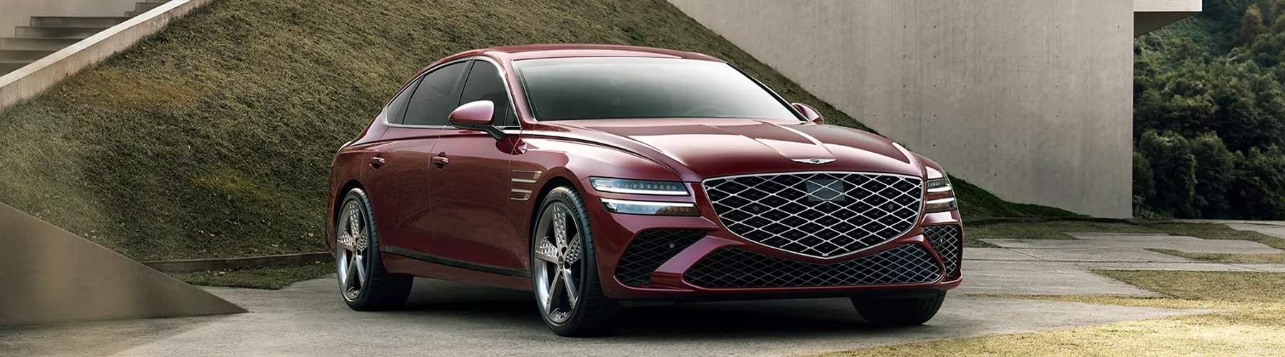 Side view of the 2026 Genesis G80 parked near modern architecture, highlighting its elegant profile and design lines