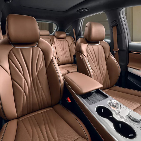 Interior view of Genesis GV70's front and rear seats in brown leather