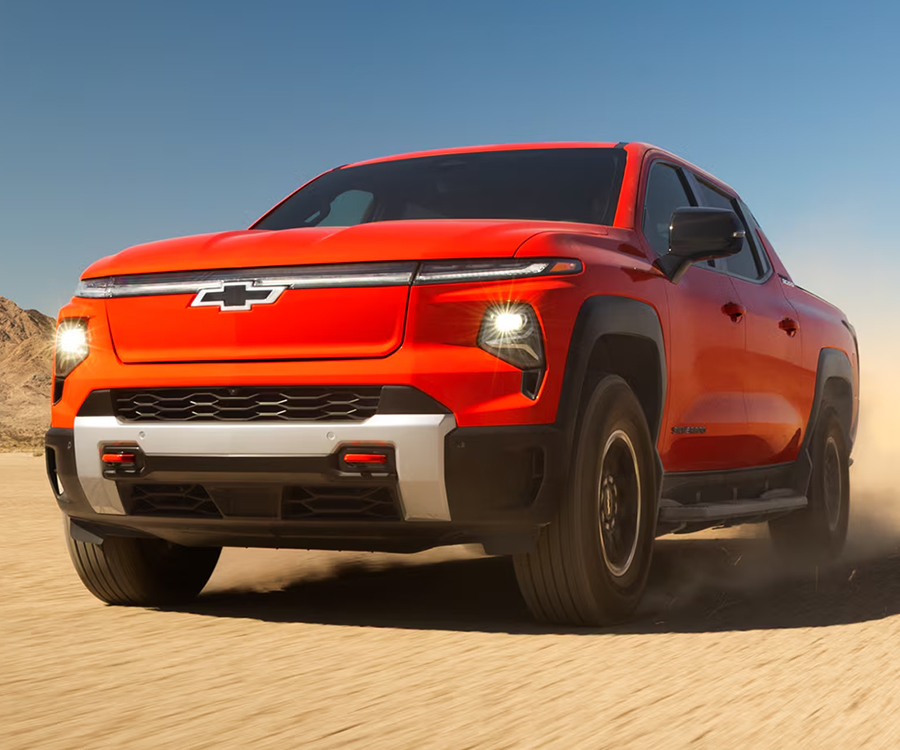 Three Quarters View of an Orange 2026 Chevy Silverado EV in the Middle of a Desert