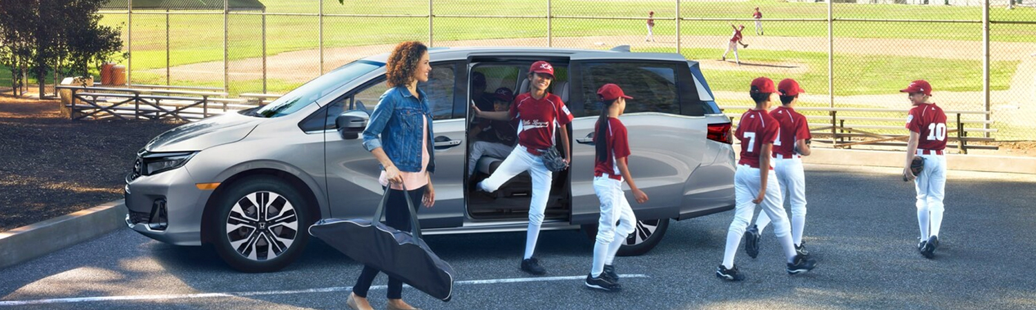 Group of young baseball players getting out of a 2026 Honda Odyssey