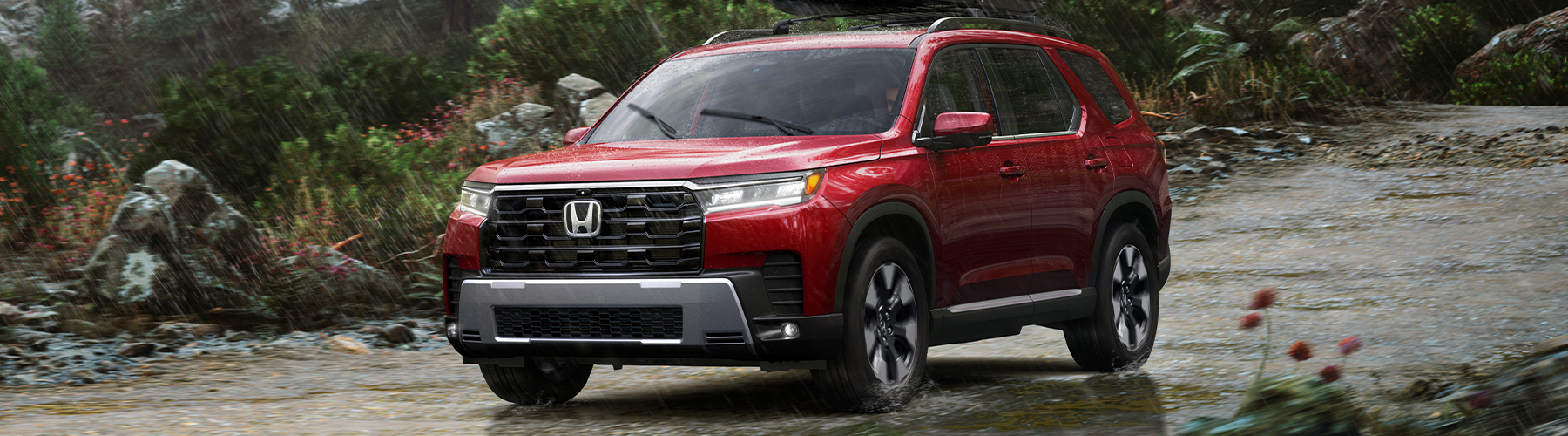 Side profile shot of the 2026 Honda Pilot driving down road