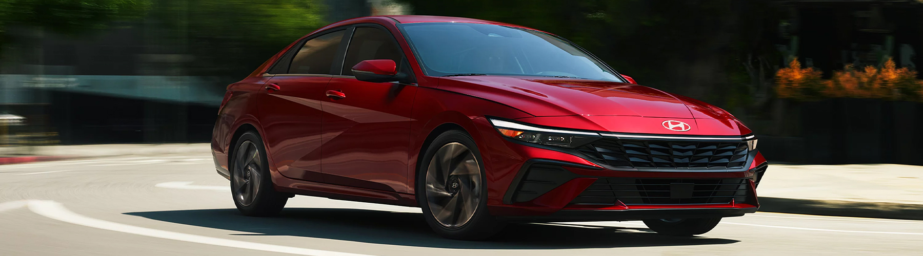 Red 2026 Elantra front 3/4 view driving