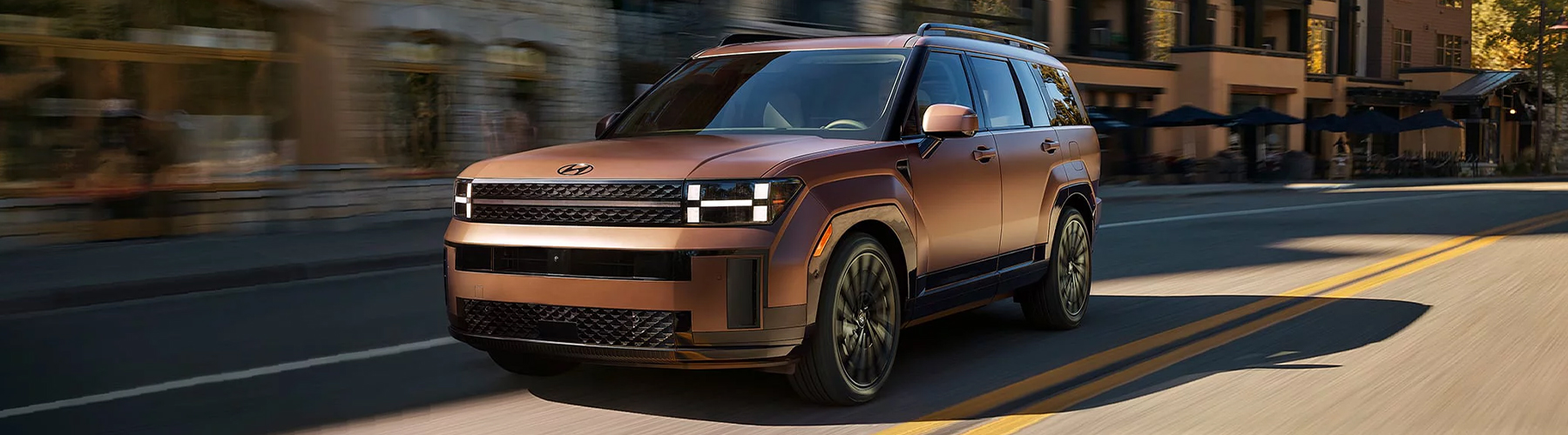 2026 Hyundai Santa Fe driving through a rural town