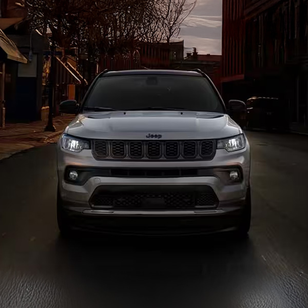 Head on shot of the 2026 Jeep Compass driving down city street