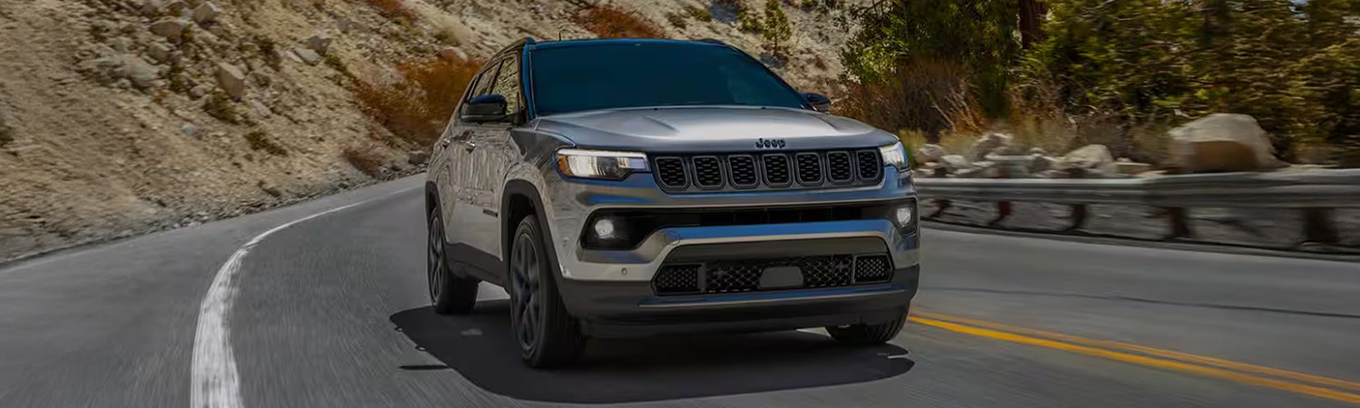 Head on shot of the 2026 Jeep Compass driving down road
