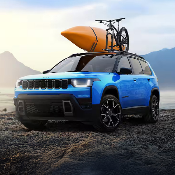 Front 3/4 shot of the 2026 Jeep Cherokee parked in front of water