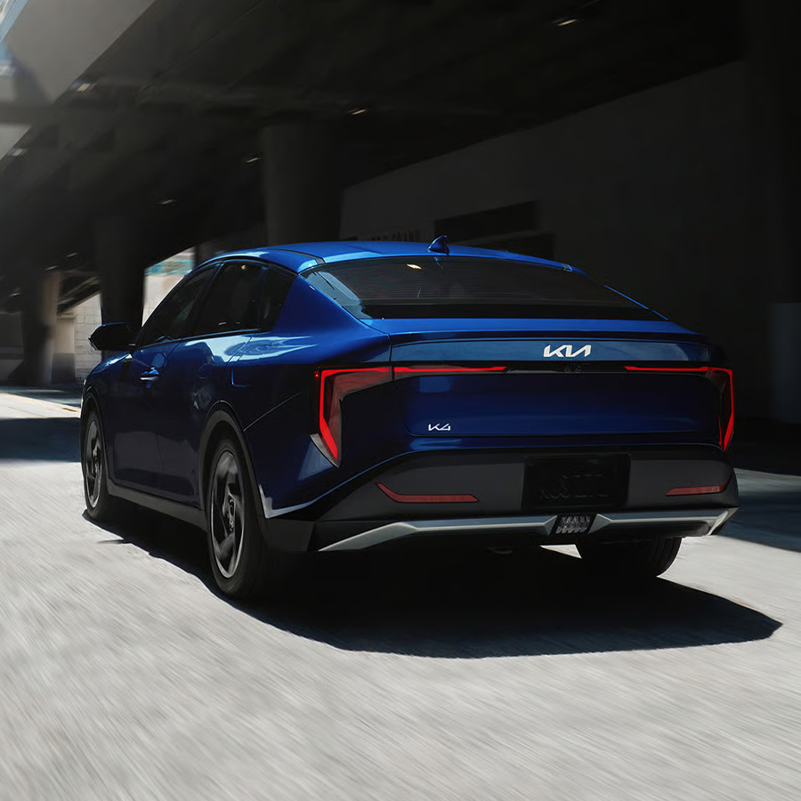 Rear view of the 2026 Kia K4 sedan EX trim in blue, featuring the LED taillights