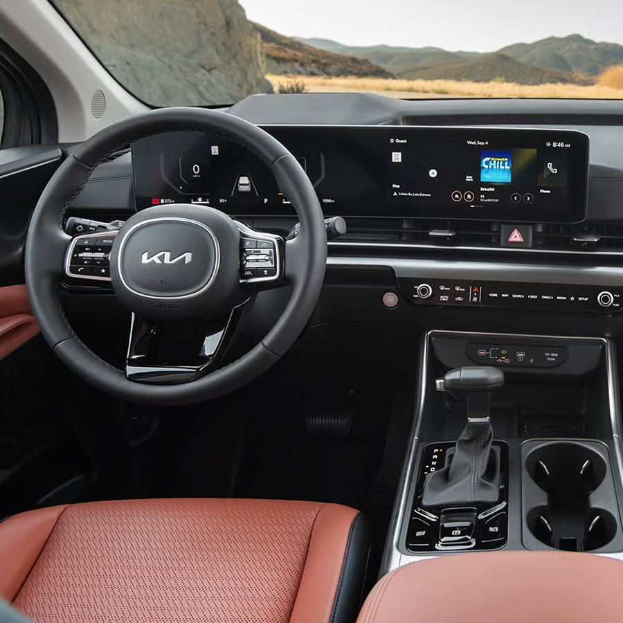 2026 Kia Carnival MPV interior, full view of the front cabin and dashboard, including the Dual Panoramic Display