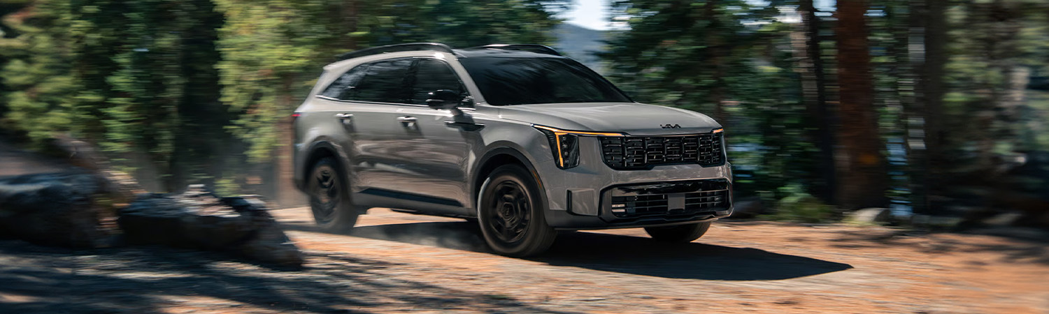 2026 Kia Sorento driving through a forest