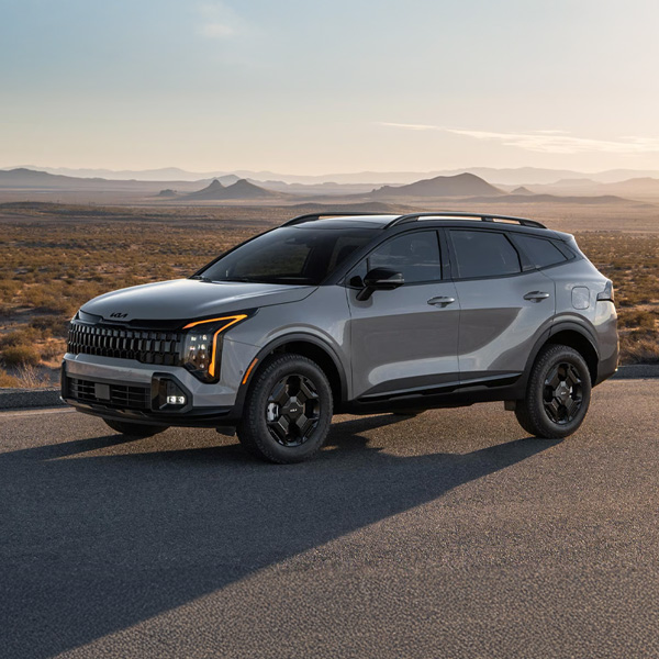 Grey 2026 Kia Sportage parked in a desert road
