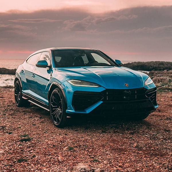 Front 3/4 shot of the 2026 Lamborghini Urus parked on dirt road
