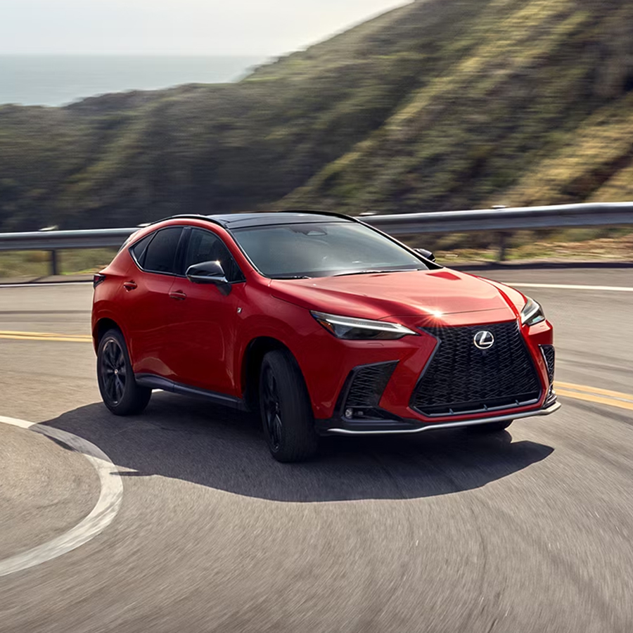 NX 350 F SPORT Handling all-wheel drive in Infrared exterior color, shown driving in the mountains.
