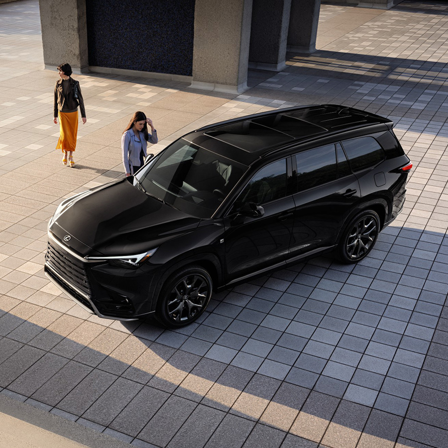 Woman looking into the passanger window of a new 2026 Lexus TX