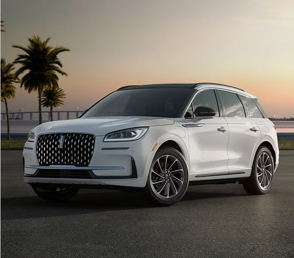 2026 Lincoln Corsair parked with palm trees and a body of water with a city in the background