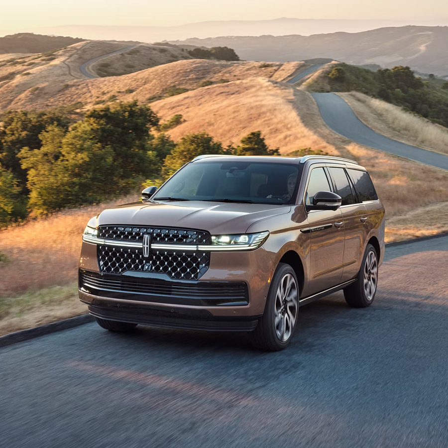 A 2026 Lincoln Black Label Navigator® SUV is being driven on a rural road
