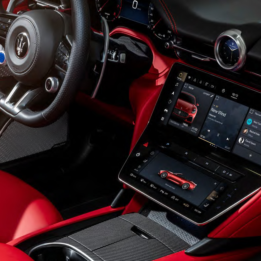 Interior of the 2026 Maserati GranCabrio showing the steering wheel, red leather cabin, and central touchscreen display.