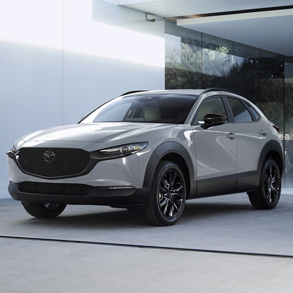 2026 Mazda CX-30 parked in a driveway in front of a modern home