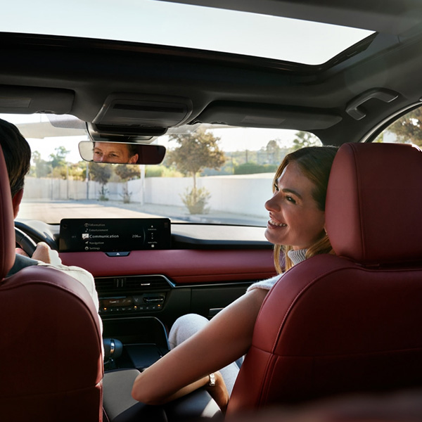 Interior view of the Mazda CX-70 cabin featuring the dashboard and panoramic moonroof.