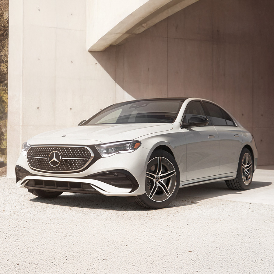 3/4 side profile view of the 2026 Mercedes-Benz E-Class parked in front of a modern house